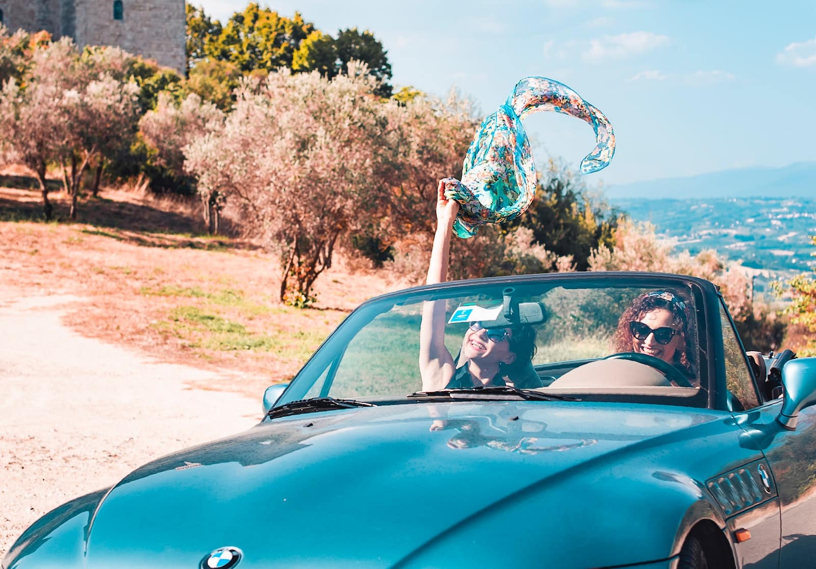 blue car on brown field during daytime